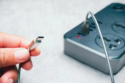 Hand carries a type C cable of smartphone charger 스톡 사진