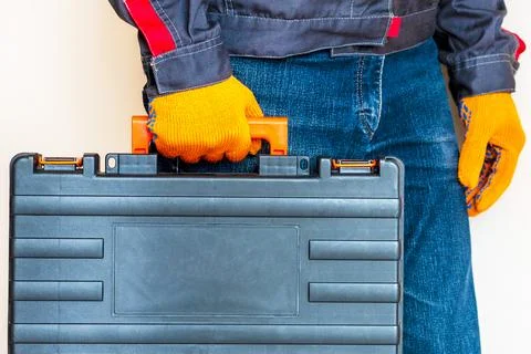 Hand with a case. gloves, tool box, person Foto stock