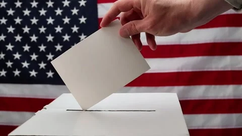 Hand casting ballot into box with usa flag Stock Footage 335520583