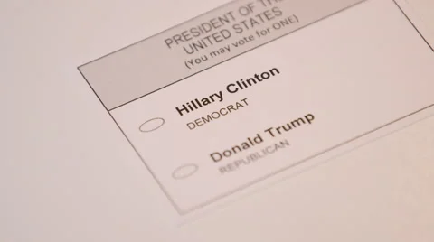 Hand casting a ballot paper to Hillary Clinton 스톡 동영상 64455398