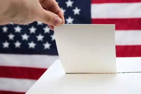 Hand casting vote into ballot box respecting democracy 스톡 사진