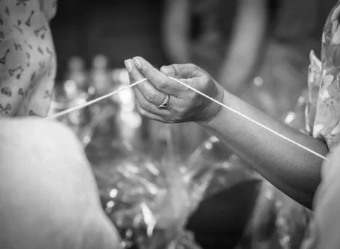 Hand catch holy thread in thai rite, black-white image Stock Photos