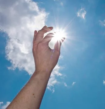 Hand catch the sun Stock Photos