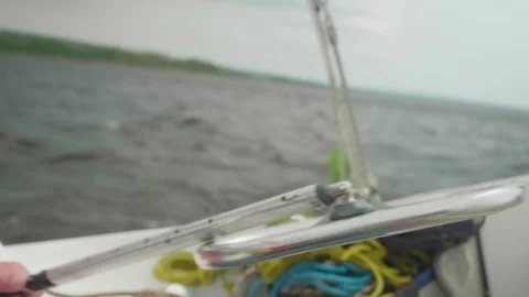 Hand of caucasian man lies on tiller of sailing yacht Stock Footage