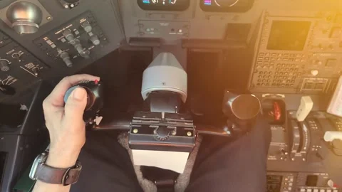 Hand of a Caucasian Pilot on the Fight Controls Inside a Jet Cockpit. Scene Stock Footage 328965105