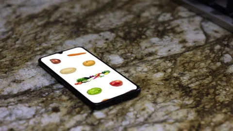 Hand with cell looking for vegetables on screen 01 Stock Footage 136064958