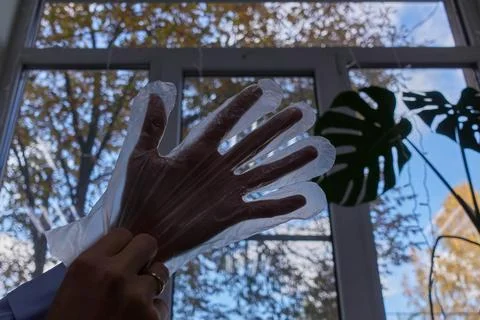 Hand in a cellophane glove. Stock Photos