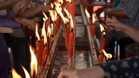 Hand cense joss stick to at an incense burne and burning candle Video stock 83791746