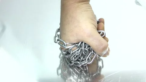 Hand with chain on a white background.  Concept of Fight and Freedom. Stock Footage 146510122