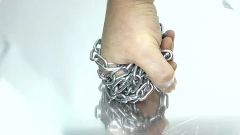 Hand with chain on a white background.  Concept of Fight and Freedom. Stock Footage 146510126