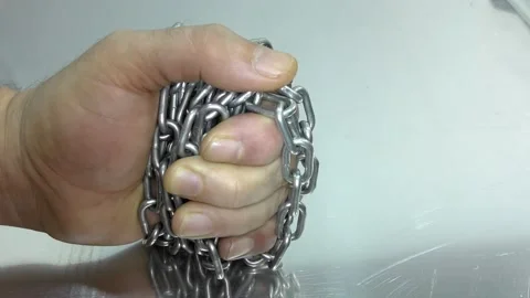 Hand with chain on a white background.  Concept of Fight and Freedom. Stock Footage 146510144