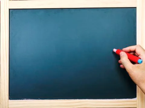 Hand with chalk at the empty blackboard Stock Photos