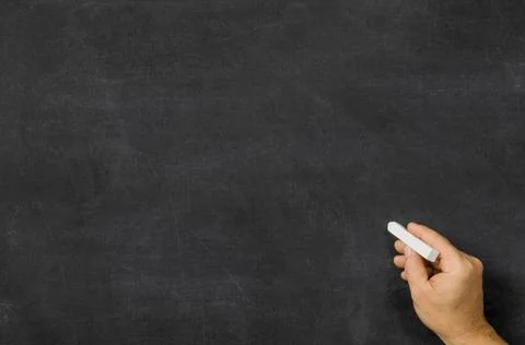 Hand with chalk in front of an empty blackboard Hand with chalk in front o... Stock Photos