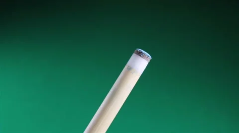 Hand chalking a pool cue with a billiards table in background Stock Footage 64837493