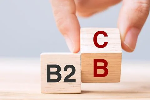 Hand change wooden cube block from B2C to B2B. E Commerce, marketing and stra Stock Photos