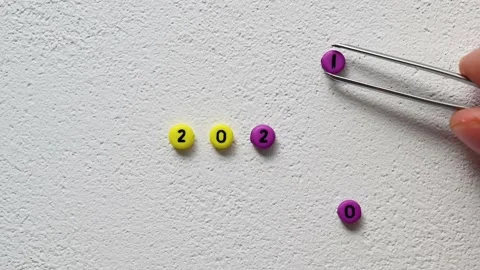 Hand changes bead with number 0 to 1, using tweezers. Change year 2020 to 2021 Stock Footage 143842147