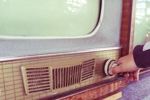 Hand changes channel. Stock Photos