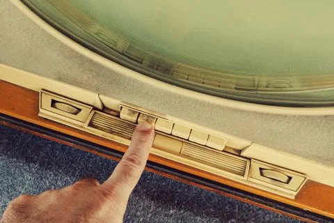 Hand changes channel. Stock Photos