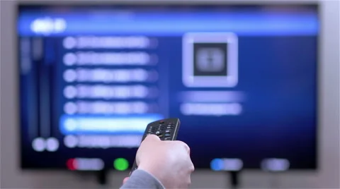 Hand changes the channels on the TV remote control Stock Footage 61122917