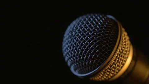 A hand is changing the head of a dynamic microphone in a half-light. Stock Footage 116846120