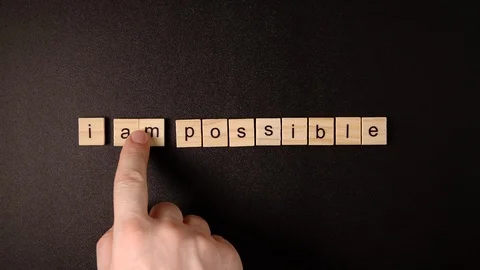 Hand changing "Impossible" to "I'm possible" Video stock 120162884
