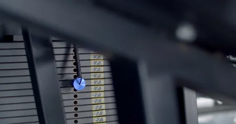 Hand changing weight on a gym machine to increase workout intensity. Stock Footage 316486059