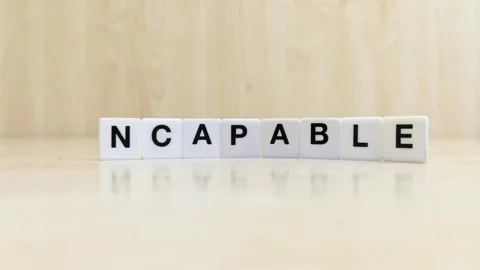 A hand changing the word capable to incapable with letters Stock Footage 246608828