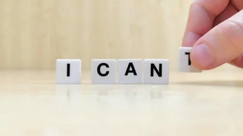 A hand changing the word i can't to i can with letters Stock Footage 246608805