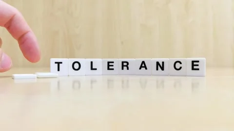 A hand changing the word intolerance to tolerance with letters Stock Footage 246608838