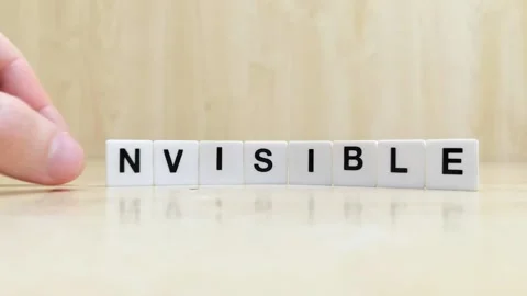 A hand changing the word invisible to visible with letters Stock Footage 246608812