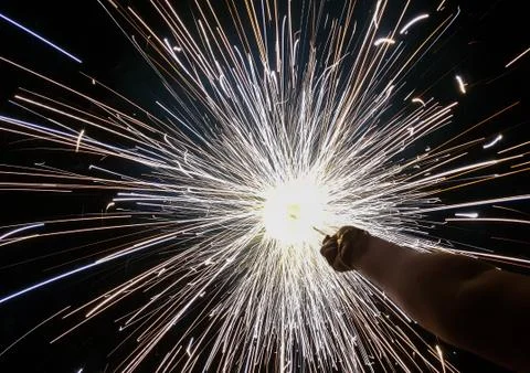 Hand charki, a hand firework emitting circular sparks in black background Stock Photos