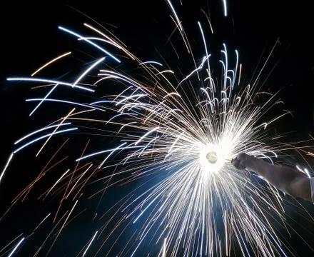 Hand charki, a hand firework emitting circular sparks in black background Stock Photos
