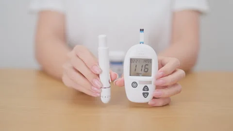 Hand checking Diabetes or Blood glucose self testing by digital blood gluco.. Stock Footage 337926039