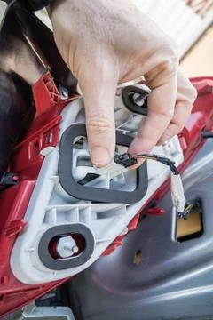 A hand checking or replacing  a taillight lamp Stock Photos