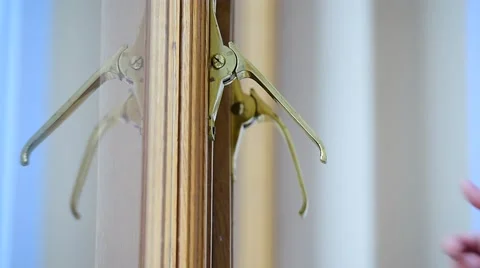 Hand checking vintage golden window handles on a wooden window frame 스톡 동영상 68164931