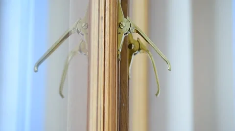 Hand checking vintage golden window handles on a wooden window frame Vídeo Stock 68164937