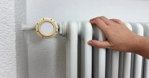 Hand Checking Warm Radiator, Heating System Home Comfort Control Stock Photos