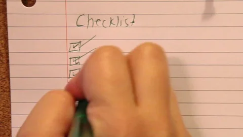 Hand checks off list Stock Footage 97599151