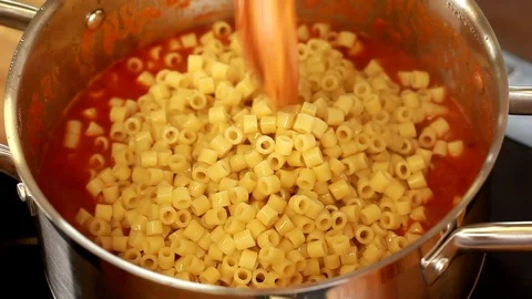 Hand of a chef cooking Bean and Ditalini Italian pasta marinara tomato sauce Stock Footage 89550928