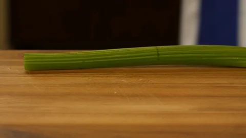 Hand of a chef cutting celery. Cooking Italian pasta with marinara tomato sauce Video stock 89543167