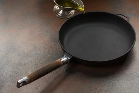 The hand of Chef preparing to pour vegetable oil to the pan Stock Photos