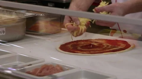 Hand chef preparing puts cheeze, ham on a pizza Stock Footage 49115564