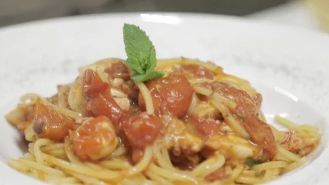 Hand of Chef Puts a Basil Leaf on Top of Pasta Dish Finished Stock Footage 86245026
