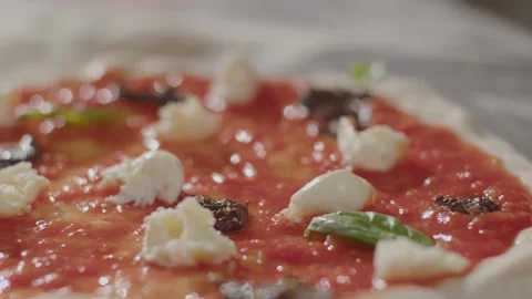 Hand of Chef Putting Basil Leaves on Pizza before Baking Video stock 261892942