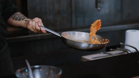 Hand chef working roasting mixed colorful vegetables tossing them in restaurant Stock Footage 100303993