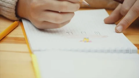 Hand of child drawing and erasing a picture in her sketch pad. Stock Footage 113070814
