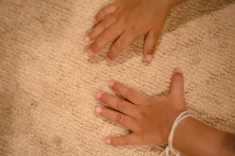 The hand of the child exposed to the surface of the table mat Stock Photos