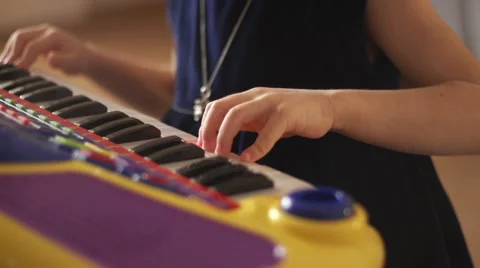 Hand of a child playing synthesizer Stock Footage 56310316