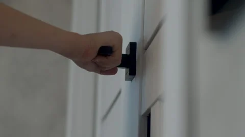 The hand of a child trying to open the interior door, pulling the handle. b.. Stock Footage 247428154
