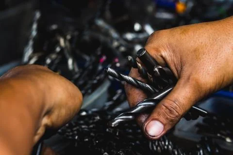 Hand choose group of drilling tools close up beautiful light Foto stock